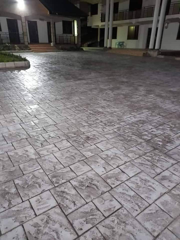 Large stamped concrete compound at a residential block, lit at night