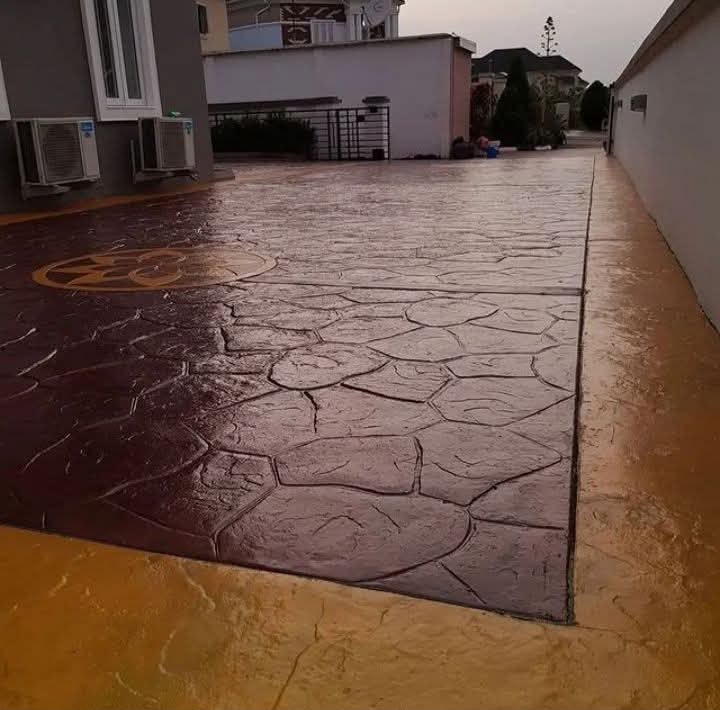 Random stone stamped concrete driveway with a decorative medallion feature